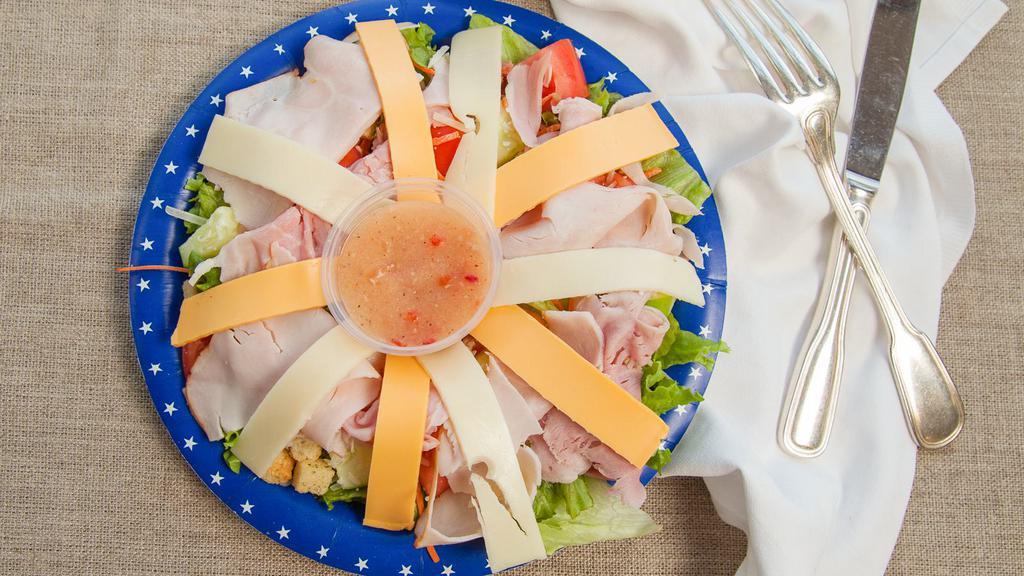 Julienne Salad · Lettuce, tomato, cucumber, onion, turkey, ham, american cheese, swiss cheese, croutons, hard boiled egg.
