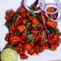 Chicken 65 · Deep-fried chicken tempered with curry leaves and green chilies and sautéed in hot red sauce.