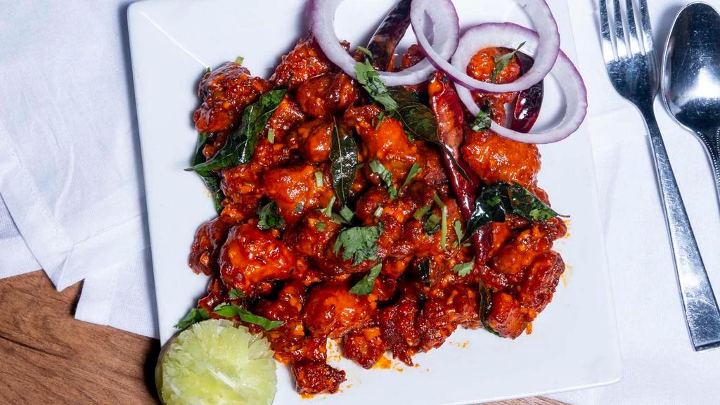 Chicken 65 · Deep fried chicken tempered with curry leaves and green chilies and sautéed in hot red sauce.