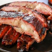 Half Slab Ribs · 1/2 slab of our honey rubbed pork spare ribs slow smoked over hickory wood and cut to order....