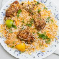 Chicken Biryani · Chicken pieces cooked with rice. Flavored with desi herbs and spices. + served with mint rai...