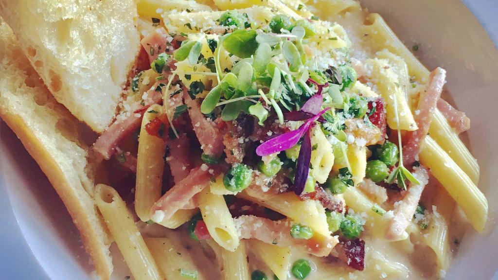 Penne Carbonara · Our stick-to-your-ribs bastardized carbonara. Garlic cream sauce with peas, parmesan, and pepper flakes. 
With Pancetta or Fried Zucchini (vegetarian)