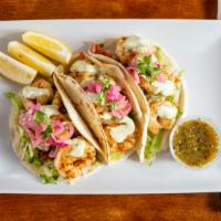 Grilled Shrimp Tacos (3) · Grilled pineapple pico de gallo, lettuce, carrot and cilantro slaw and cilantro lime mayo on...