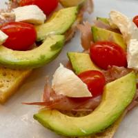 Tartine À L'Italienne · Toasted French baguette, avocado, prosciutto, tomato, burrata and olive oil. Serve with side...