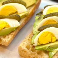 Tartine Mp · Toasted French baguette, avocado, hard boiled egg, cornichon and olive oil. Serve with side ...