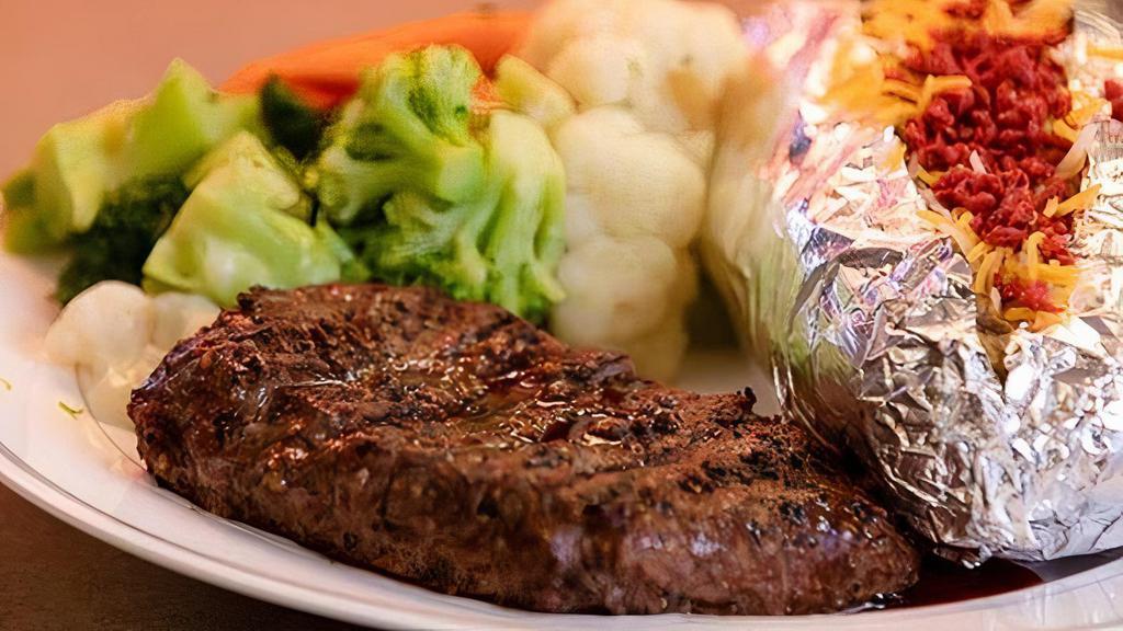 Steak · Ribeye steak with loaded Potato and steamed vegetables.