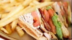 Turkey Club Sandwich · Served with french fries and a 20 oz soft drink.