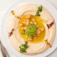 Hummus · Chickpeas with tahini (sesame paste) lemon and olive oil, with pita bread.