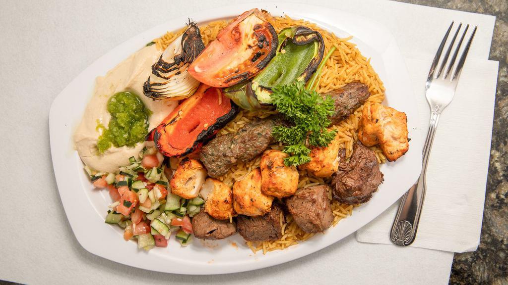 Pita Palace Mix Grill · Three skewers of grilled kabob (shish kabob, katta kabob, chicken shish tawook) and rice, comes with grilled tomatoes grilled onions.