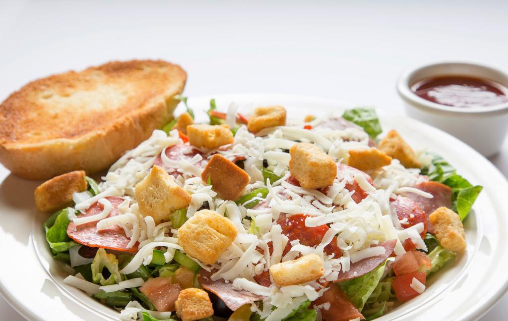Antipasto Salad · Lettuce mix, red onions, green peppers, olives, pepperoni, salami, tomatoes, mozzarella and cheddar cheese, sliced egg, croutons, choice of dressing, and a slice of garlic bread.