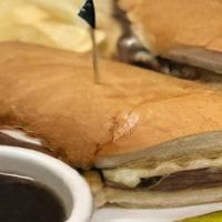 French Dip · Thinly sliced roast beef stacked on a toasted hoagie bun with melted mozzarella, served with...