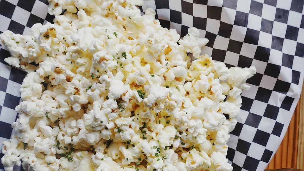 Truffle Popcorn · Popcorn tossed in truffle oil and parmesan, with chives sprinkled on top. Warning! This will forever raise your standard for popcorn.