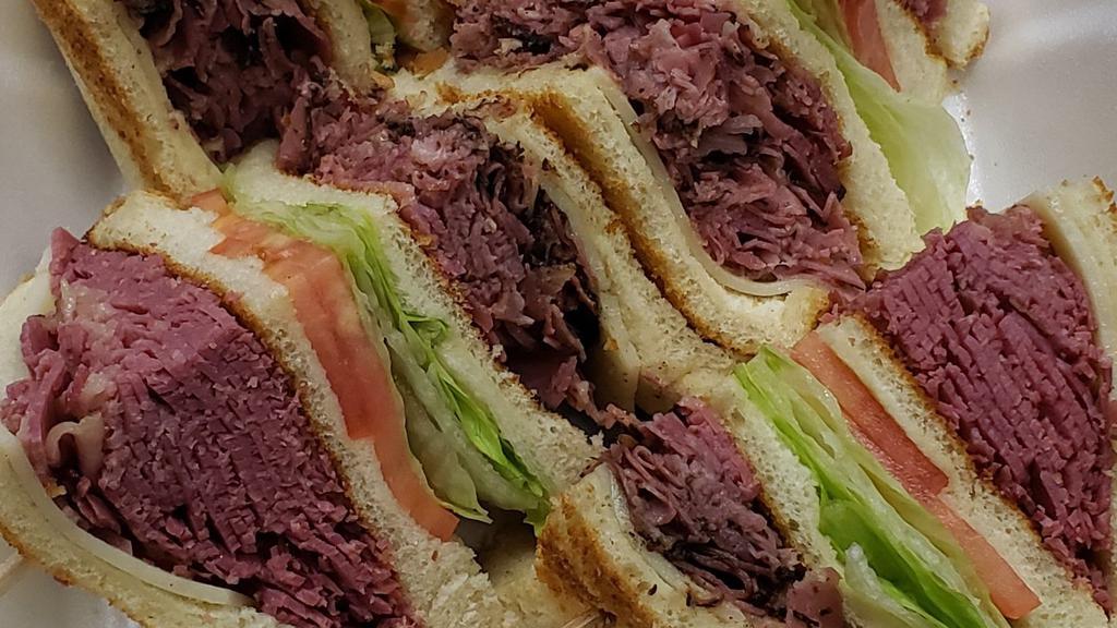 Jason'S Jammer · Corned Beef, Naval Pastrami, Swiss cheese, lettuce, tomato, dressing served on 4 slices of white toast.

NOTE: This sandwich has Russian Dressing on it. If you do not wish to have Russian Dressing, please select 