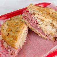 Reuben · Corned beef, hot sauerkraut, melted Swiss cheese and Russian dressing on grilled rye.