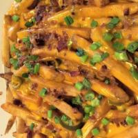 Cheese Fries · Choice of hand cut fries, waffle fries or tater tots. Smothered in queso. Chopped hickory ba...