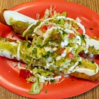 Flautas · Two fried flautas stuffed with shredded chicken topped with lettuce, tomatoes, onions and so...