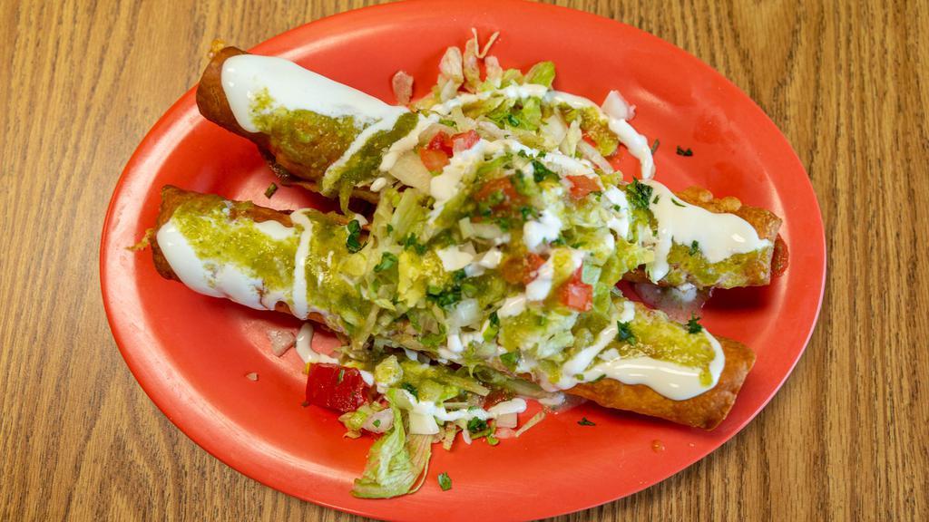 Flautas · Two fried flautas stuffed with shredded chicken topped with lettuce, tomatoes, onions and sour cream.