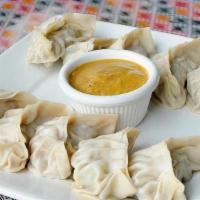 Jhol Momo Vegetable · Veg momo dipped in sauce: tomato, onion, ground soy, and sesame seeds, nepali spices.