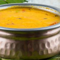 Daal Tadka (Yellow Dal) · Yellow lentil cooked with ginger, garlic, tomato, onion sauce, and Indian spices.