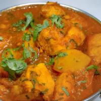 Chicken Curry · Boneless, Leg meat cubed chicken cooked with onions, tomatoes, fresh ginger, garlic, and Ind...