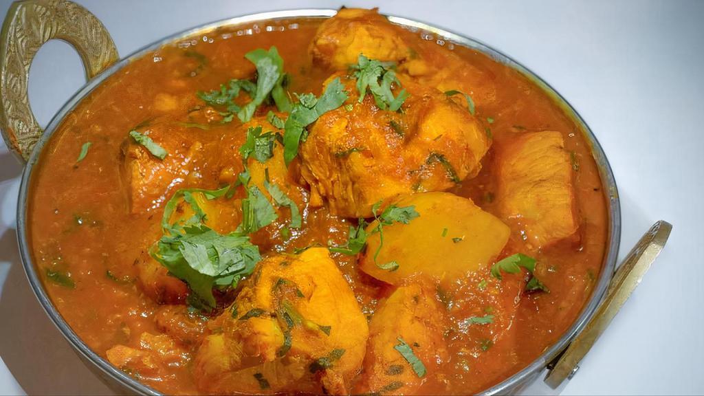 Chicken Curry · Boneless, Leg meat cubed chicken cooked with onions, tomatoes, fresh ginger, garlic, and Indian spices.