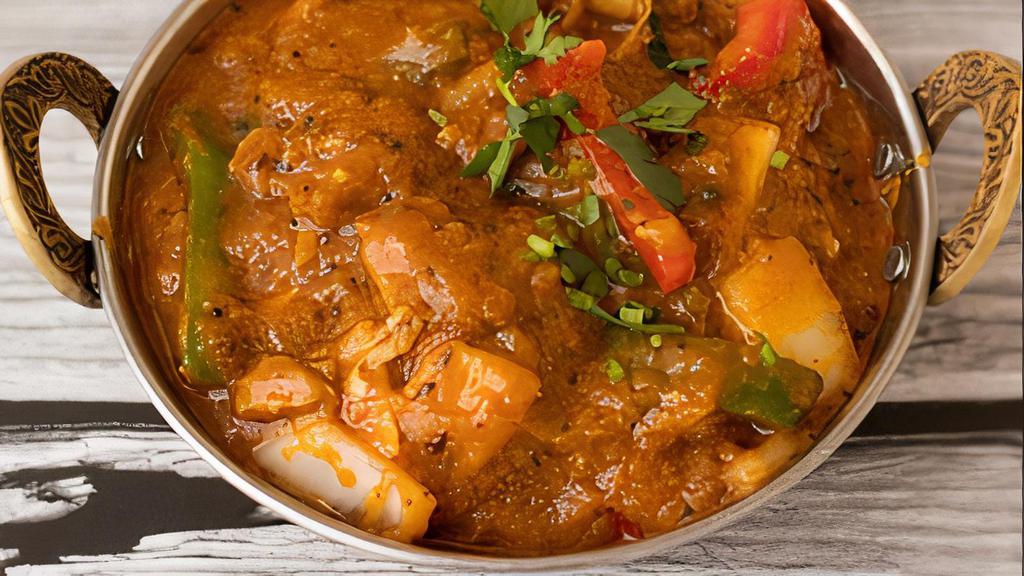 Kadai Chicken · Boneless, Leg meat chicken cooked with, onion, tomato, ginger, garlic, bell peppers, and Indian spices.
