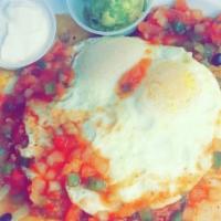 Huevos Rancheros · Two eggs, served with fried tortilla shells, chorizo, black beans, onion and green peppers, ...