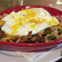 Corned Beef Hash · Two eggs with corned beef hash and hash browns.