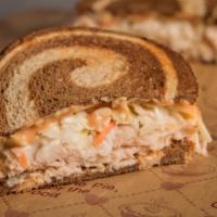 Turkey Reuben Sandwich · Michigan turkey, creamy coleslaw, Thousand Island and Swiss on marbled rye. Served with a pi...