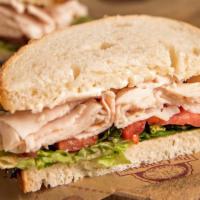 Classic Turkey Sandwich · Michigan turkey, tomato and lettuce with mayo on sourdough bread. Served with a pickle and c...