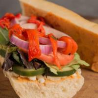 Mediterranean Veggie Sandwich · Roasted red pepper, red onion, cucumber, tomato, feta, lettuce and red pepper hummus on an h...