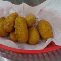 Jalapeño Poppers · Jalapeños cut in half and filled with cream cheese, lightly breaded and deep fried. Served w...