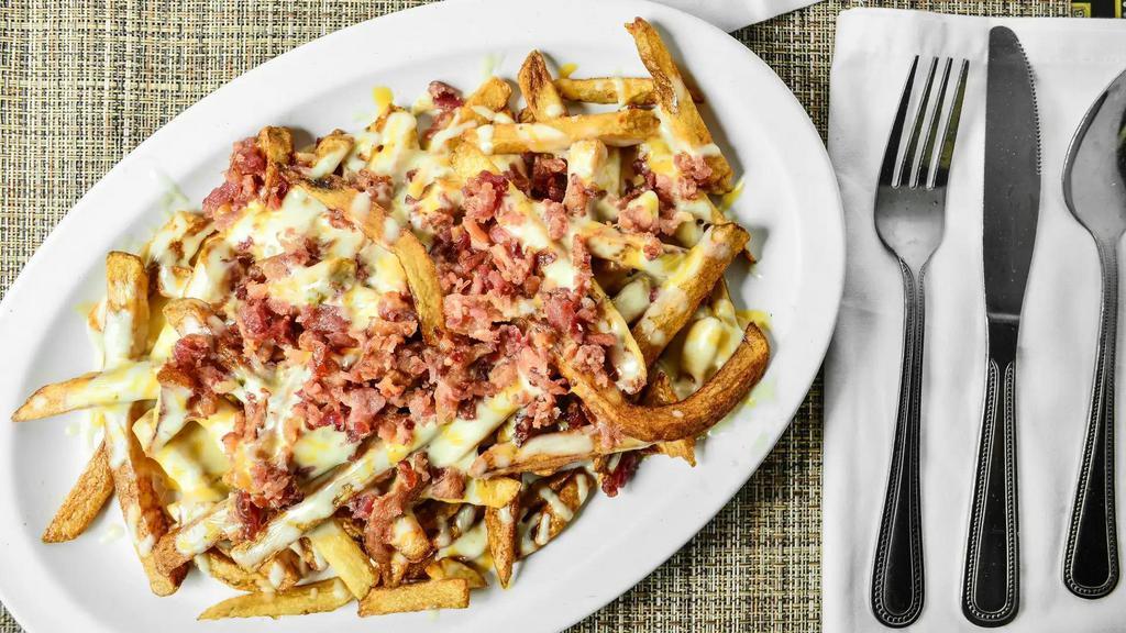 Large Bacon Cheese Fries · Fresh cut fries (Tossed in our 'Ron's Seasoning Salt') topped with a blend of melted pepper jack & American cheese and bacon pieces. Served with a side of dipping sauce.