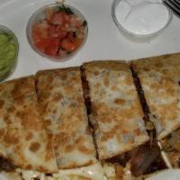 Quesadilla Fajita · Grilled steak or chicken with bell peppers and onions smothered with melted cheese. Side of ...