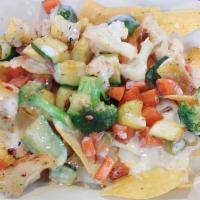 Veggie Nachos · A mix of fajita veggies served over tortilla and smothered with white cheese sauce.
