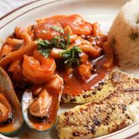 Pescado A Lo Macho · Grilled fish fillet with shrimps, octopus, squid, mussels, topped with a red creamy sauce, s...