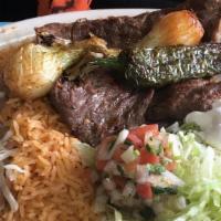 Carne Asada · A succulent grilled beef steak, chile toreado with grilled onions, served with rice, beans, ...