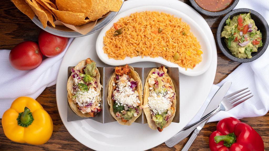 Cucos Tacos Locos · Three corn or flour taco shells spread with guacamole and filled with marinated chicken strips, spicy sweet coleslaw and feta cheese, served with Mexican rice.