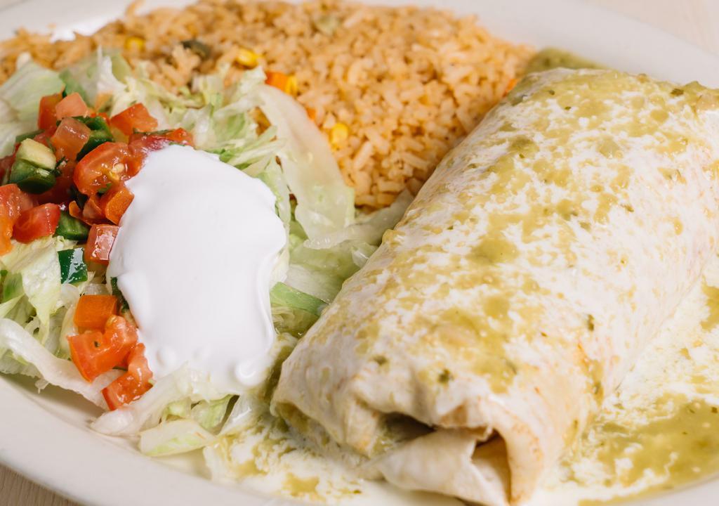 Burrito Chicago · Big burrito filled with steak, chorizo and refried beans, topped with Verde sauce and cheese sauce, served with Mexican rice lettuce, sour cream and pico de gallo.