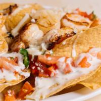 Seafood Nachos · Nachos with grilled shrimp and scallops topped with pico de gallo.