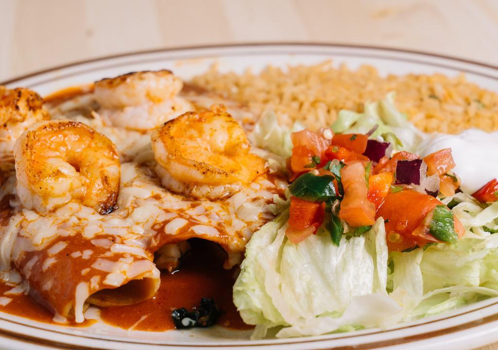 Seafood Enchiladas · Enchiladas stuffed with jumbo shrimp, scallops and spinach topped with enchilada sauce, served with Mexican rice, lettuce, sour cream and pico de gallo.