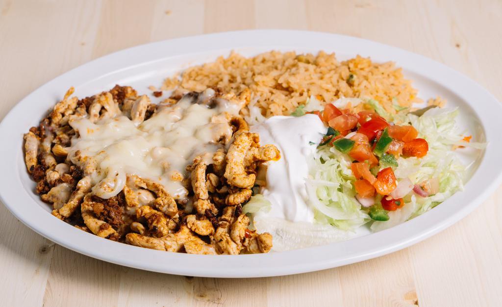 Chori Pollo · Grilled chicken strips and chorizo topped with melted cheese and served with Mexican rice, lettuce, sour cream, pico de gallo and flour tortillas.