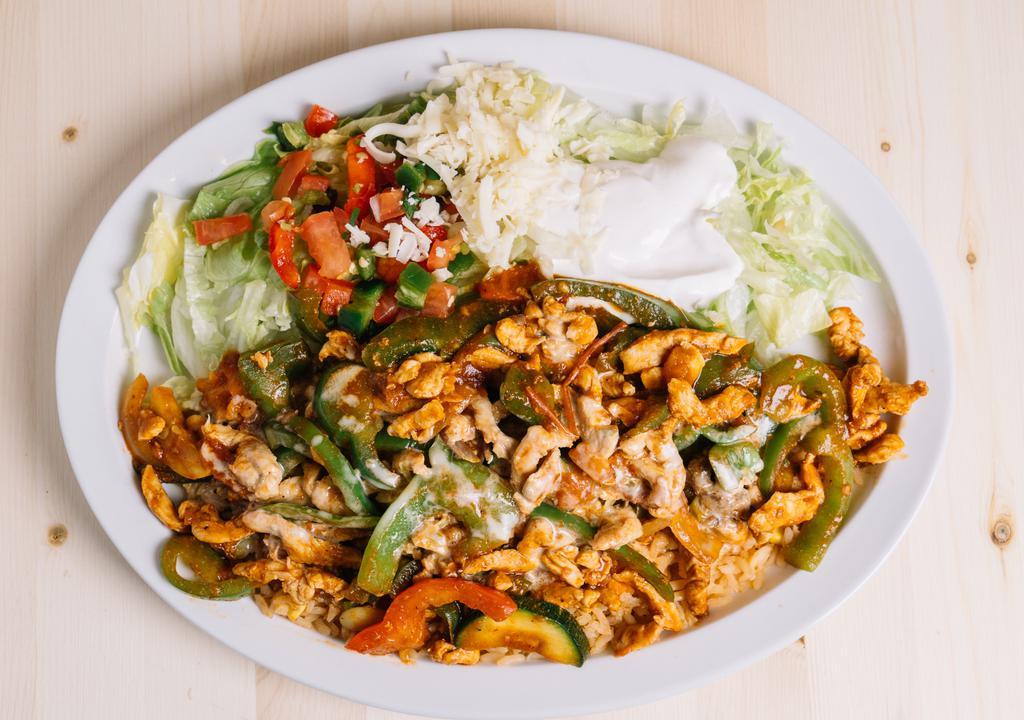 Yucatan Special · Grilled chicken or jumbo shrimp and grilled vegetables sautéed with Yucatan sauce on a bed of maxicon rice with cheese sauce on top, served with lettuce, sour cream, pico de gallo and flour fortillas.