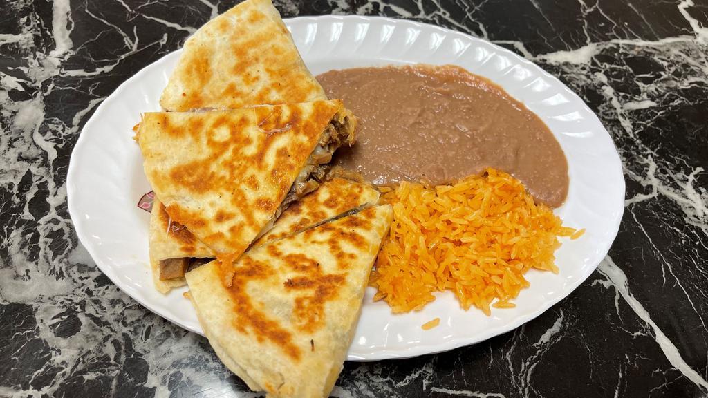 Quesadilla · 10’ Flour tortilla with melted cheese, meat your choice, rice and beans by the side.