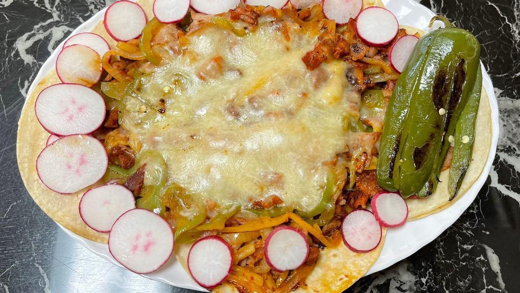 Alambre · Plate with tortillas, meat of your choice, bell peppers, bakon, grilled onions & melted cheese on top.