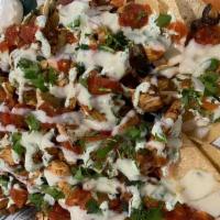 Loaded Nachos Or Totchos · Fresh fried corn chips or tots, queso, onions, jalapeños, tomatoes, olives, sour cream, and ...