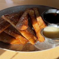 French Toast Sticks · Served with vanilla frosting and maple syrup.