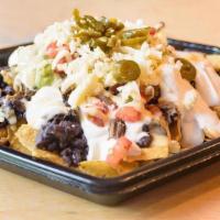 Steak Nacho · Chips piled with queso, black beans, pico de gallo, Monterey Jack cheese, jalapeños, and gri...