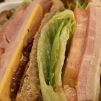 Club Sandwich · Ham and turkey served with bacon, lettuce, tomato, American and Swiss cheese on choice of to...