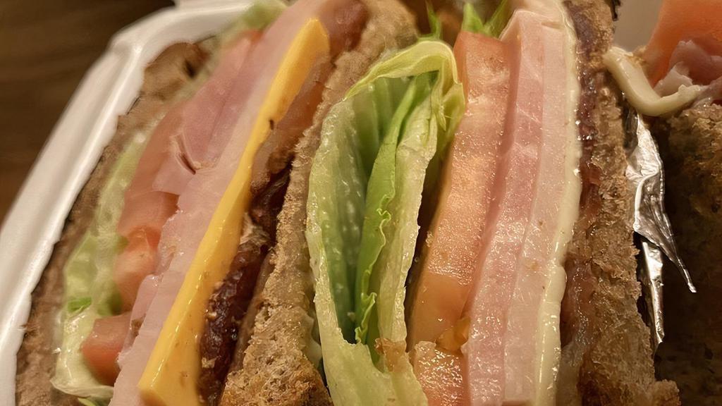 Club Sandwich · Ham and turkey served with bacon, lettuce, tomato, American and Swiss cheese on choice of toasted bread.